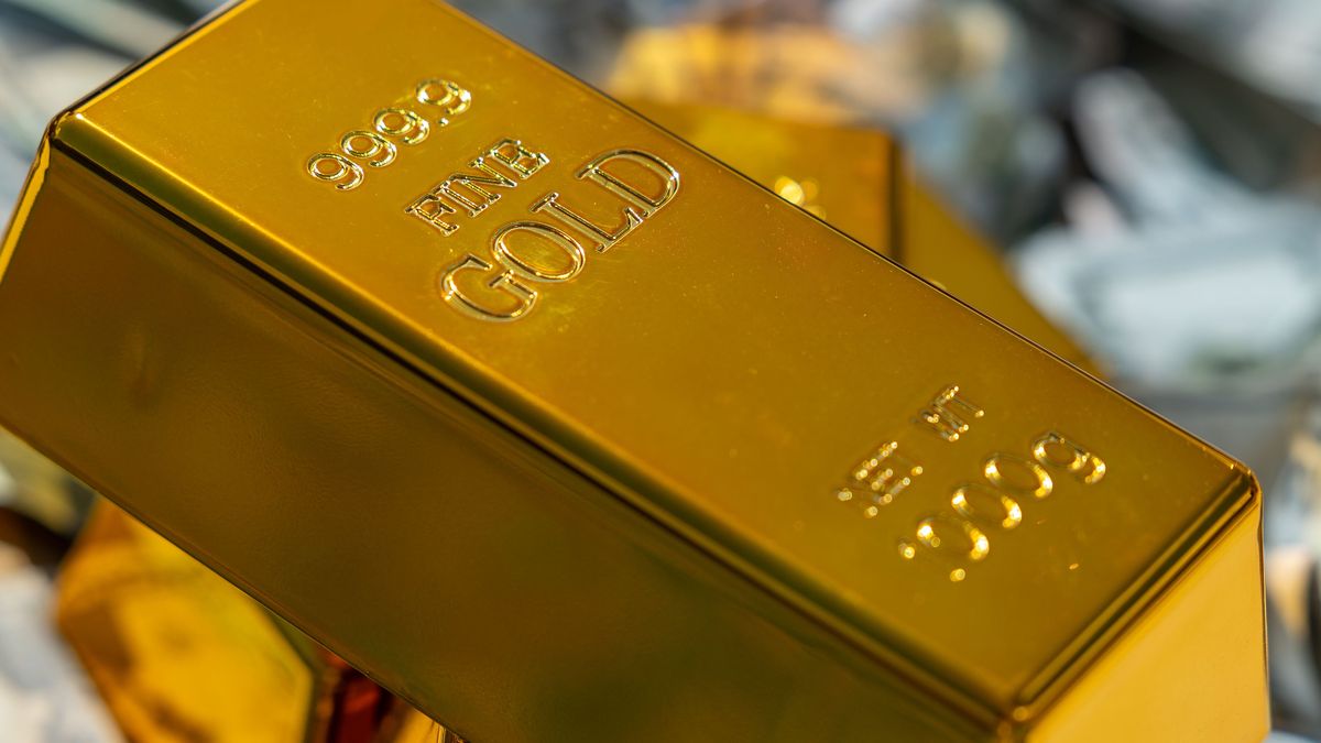 Gold bar resting on crumpled banknotes