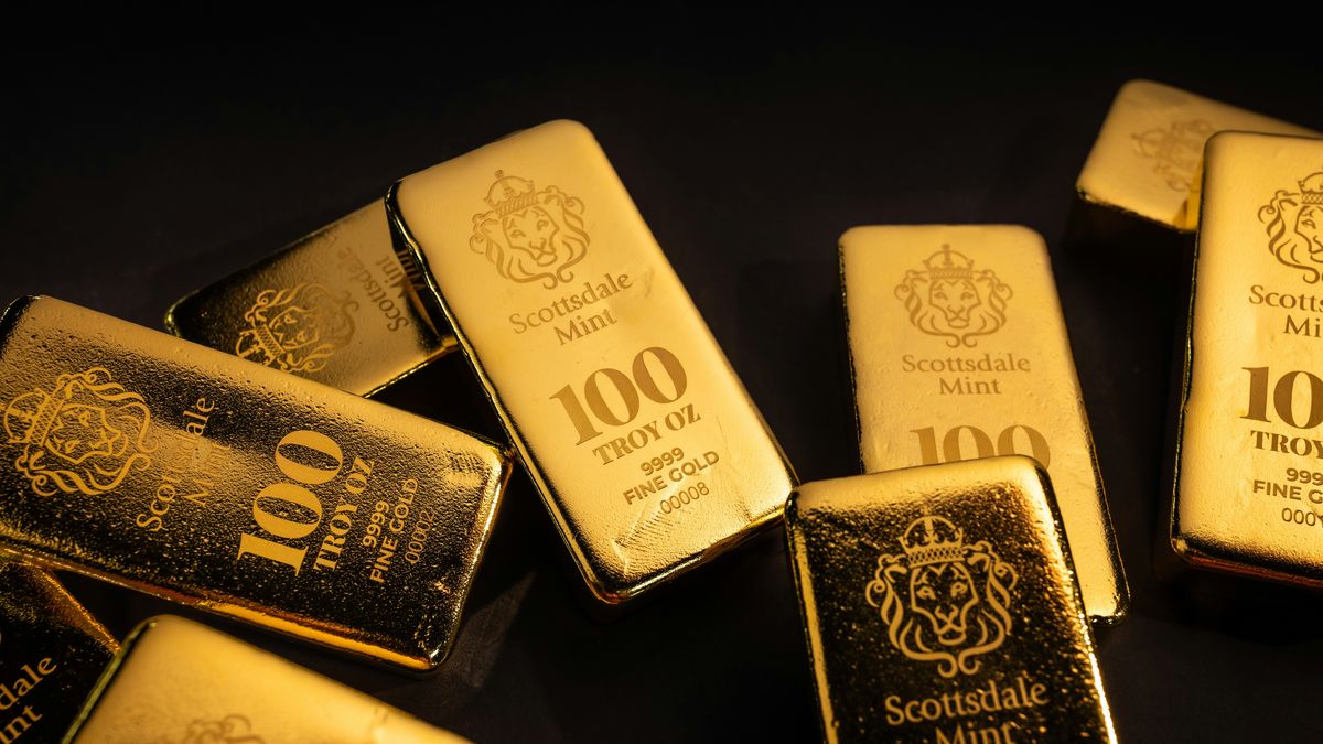 100 troy ounce gold bars on a black background