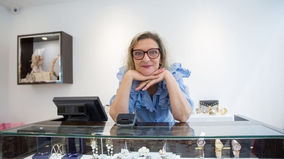 Jeweller and gold dealer at her shop counter